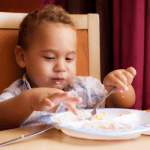 young boy eating