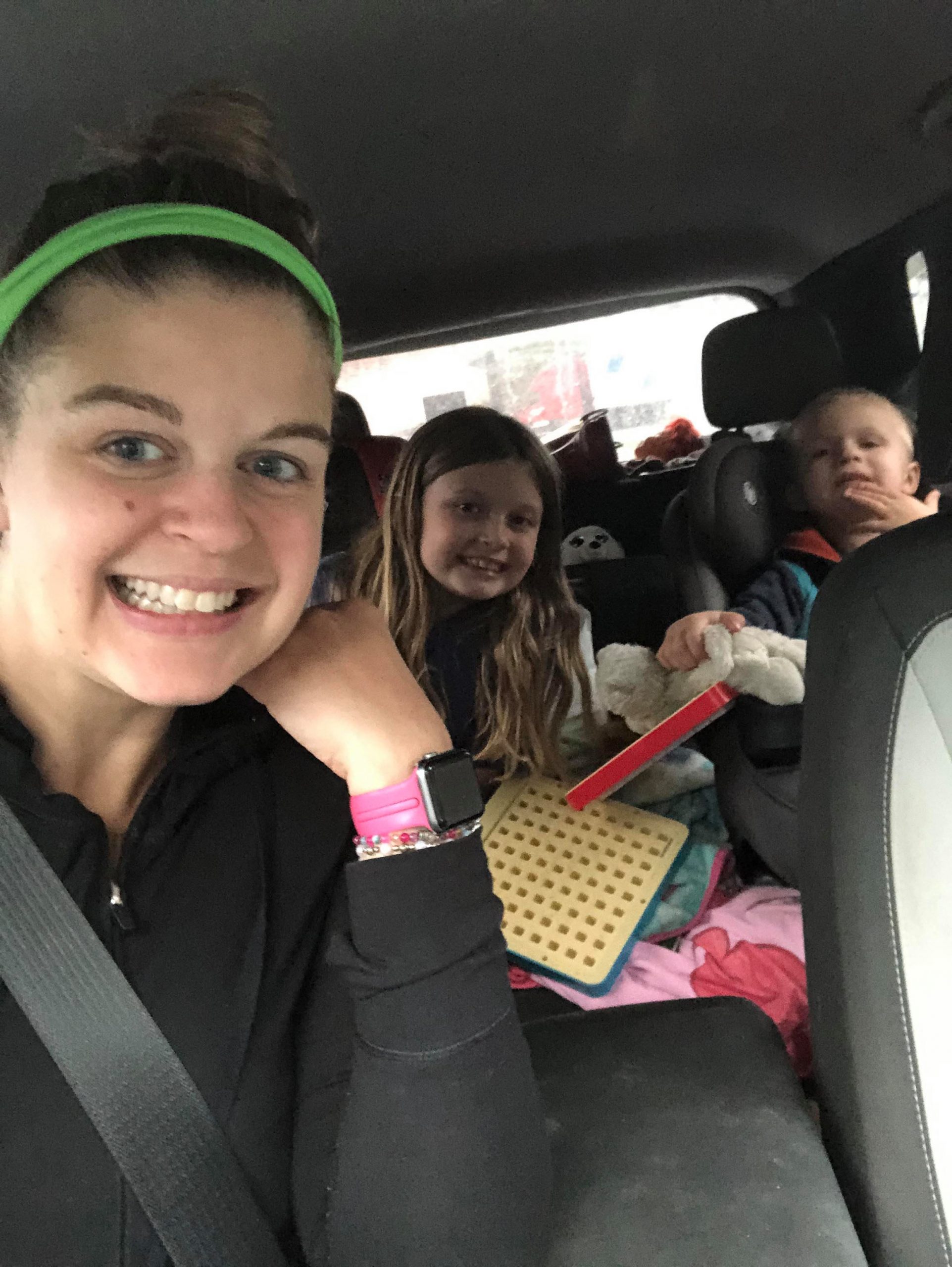 mother and two young children in a car.