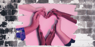 My Kids Taught Me How to Love Valentine’s Day Women's hand form a heart on a pink background in an expression of love.