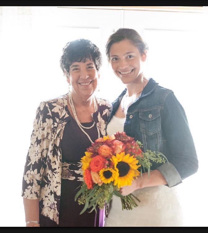 mother and daughter holding flowers