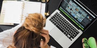 Get In The Work Zone: Five Tips to Work More Efficiently Woman working at a computer, head in hands