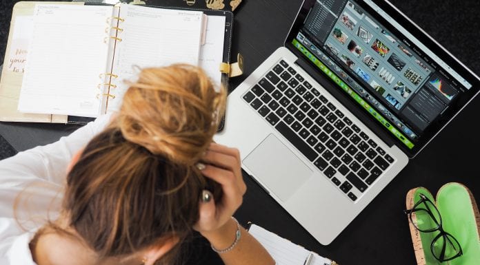 Get In The Work Zone: Five Tips to Work More Efficiently Woman working at a computer, head in hands