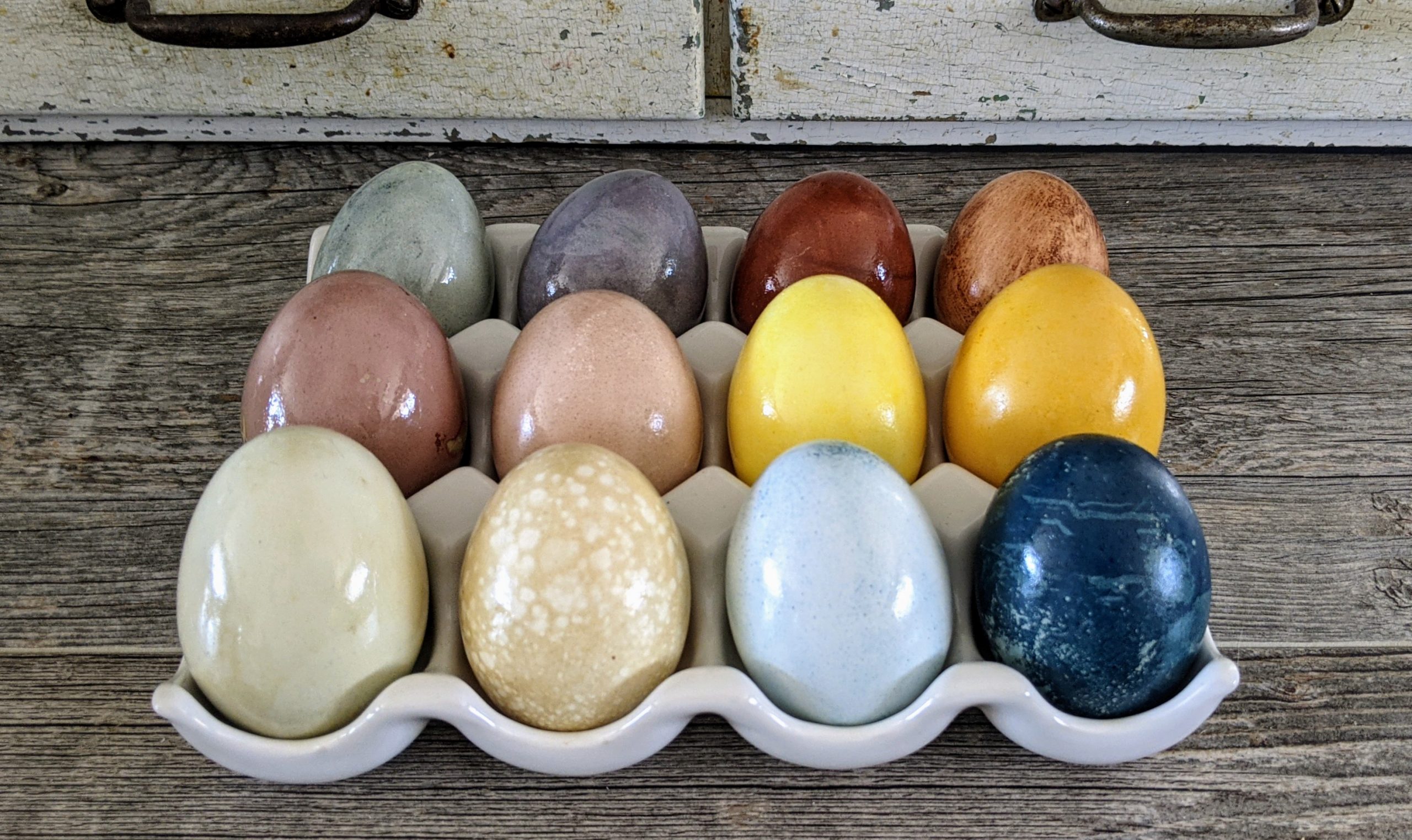 dyed easter eggs displayed in a ceramic tray