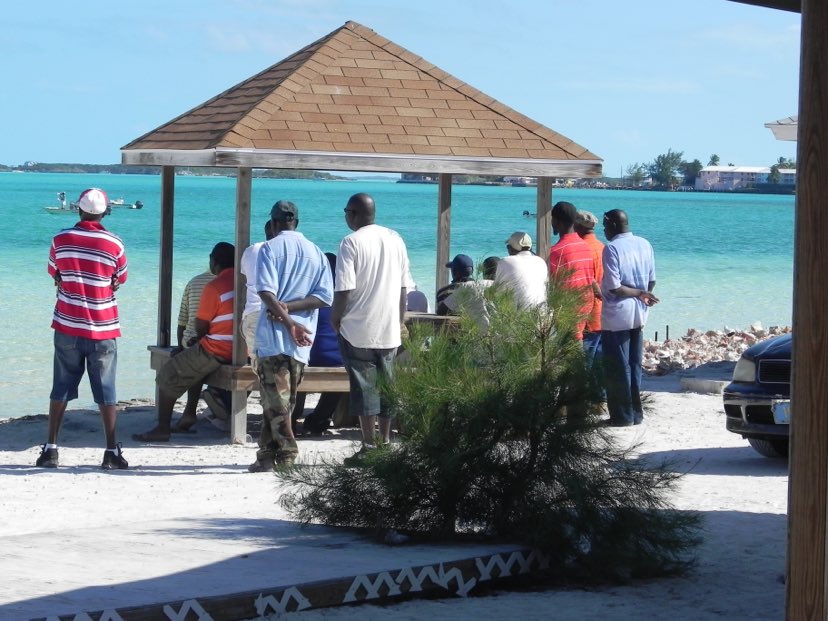 men sitting overlooking the Caribbean sea