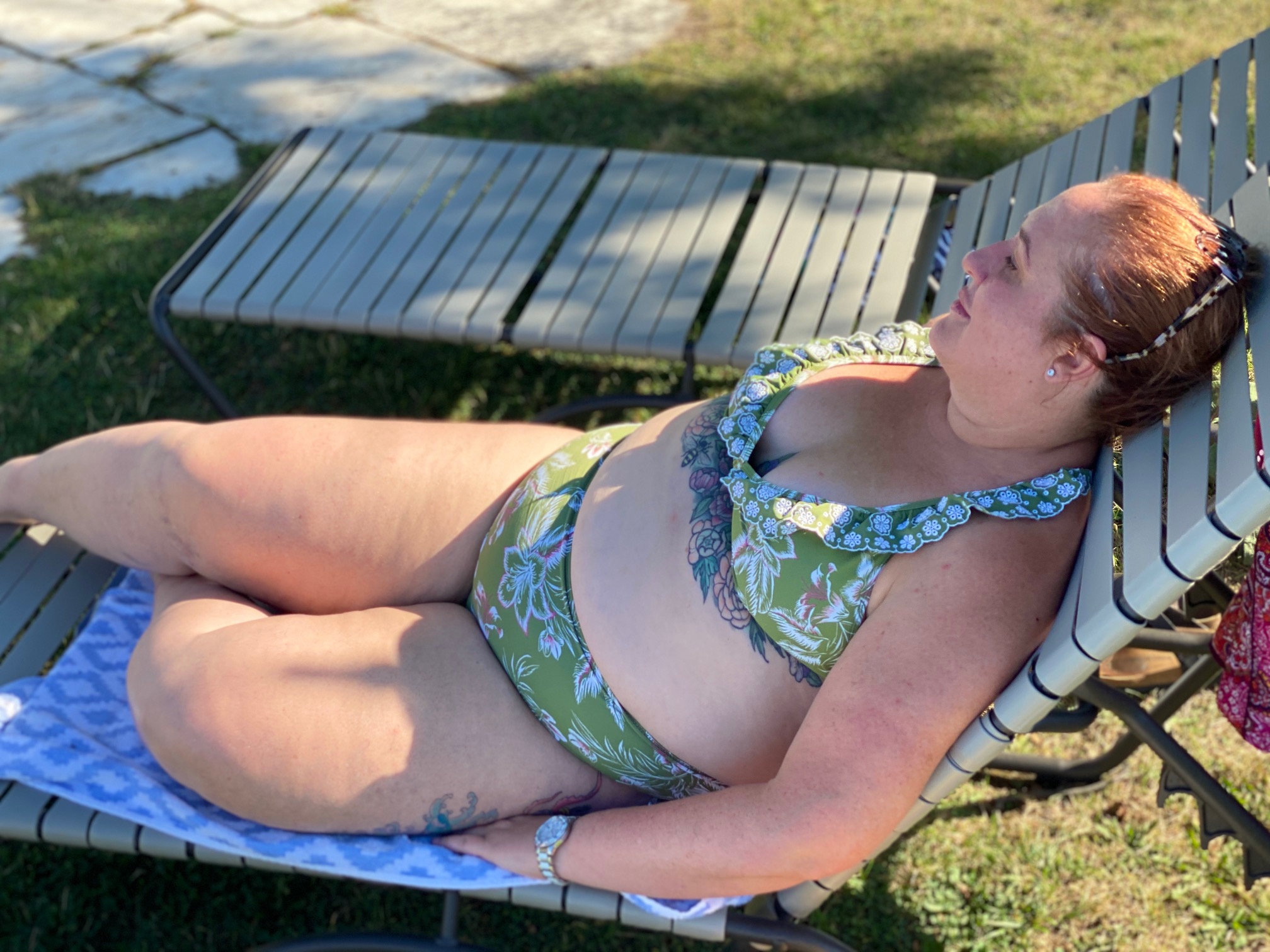 beautiful fat woman reclines on a lounge chair in a bikini