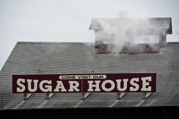 smoke and steak coming out of the smokestack of a Vermont maple sugaring house.
