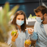 couple wearing masks while grocery shopping