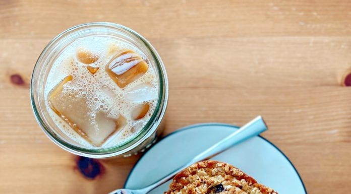 Easy Breakfast Recipe: Blueberry Oat Milk Pan Muffins Viewed from above, an iced coffee next to a plate with oat milk blueberry muffin square