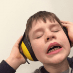 autistic child wearing headphones