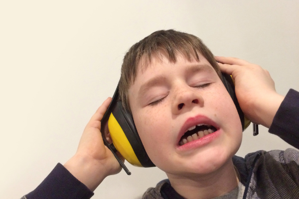boy wearing yellow headphones