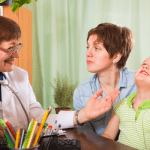 mother of autistic child talks with doctor