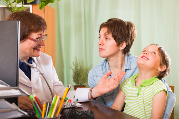 female doctor speaks with mother of autistic child.