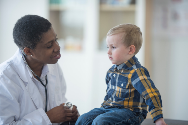 Black doctor with white child