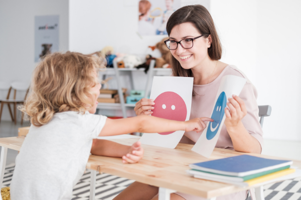 Speech Language Pathologist works with autistic child