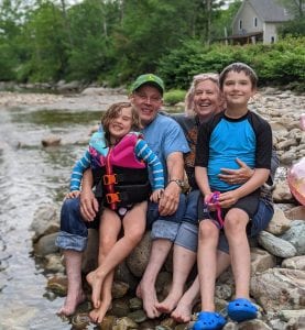 father in law, mother in law, and grandchildren by a river 