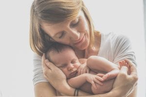woman cradles baby