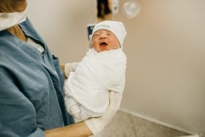 doctor holds newborn