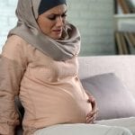 pregnant-woman-hijab-feeling-belly-pain-risk-misbirth-prenatal-care-pregnant-woman-hijab-feeling-belly-pain-risk-145145501