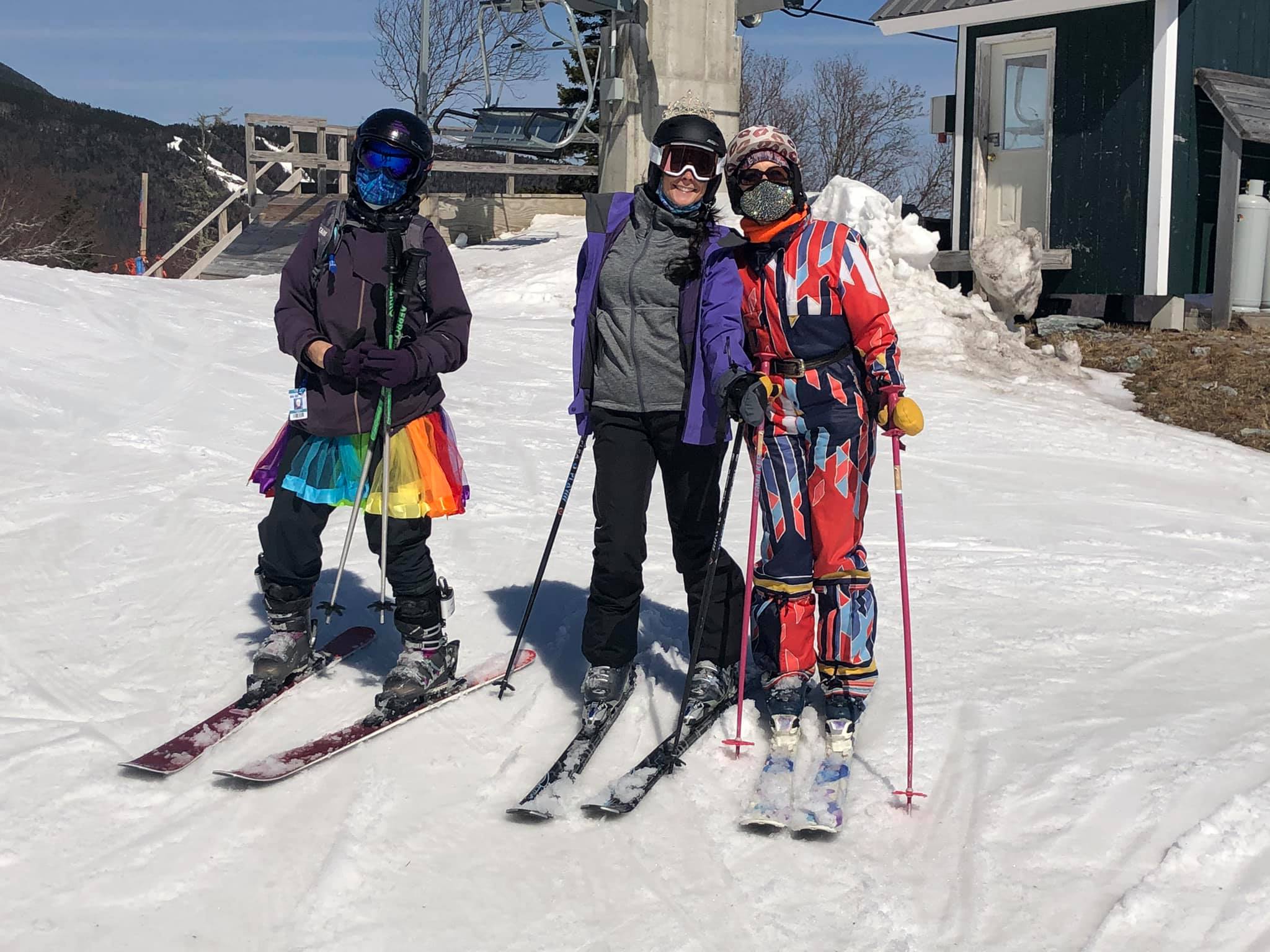 mother and daughter and an unidentified woman, in colorful skiing outfits.