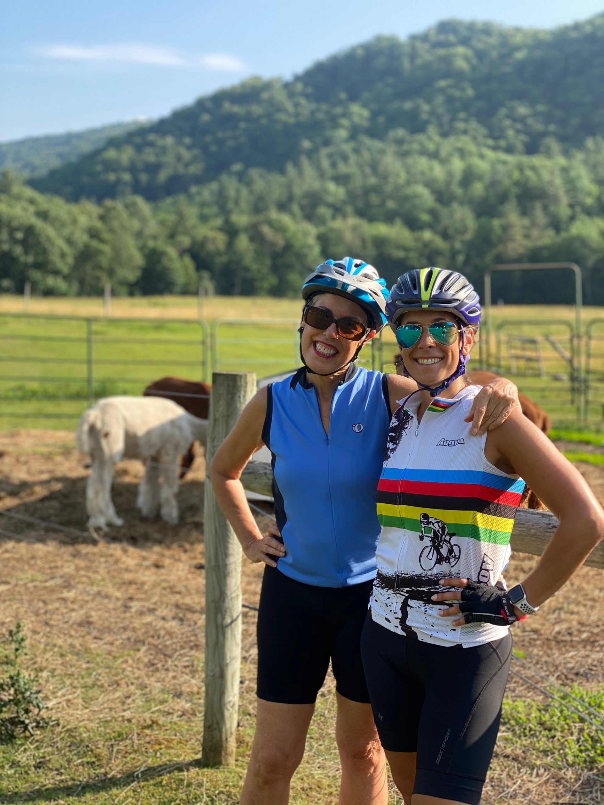 mother and daughter in biking outfits in front of a farm