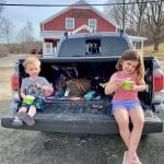 Kids eating ice cream on the back of a truck