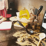 child standing on counter while cooking