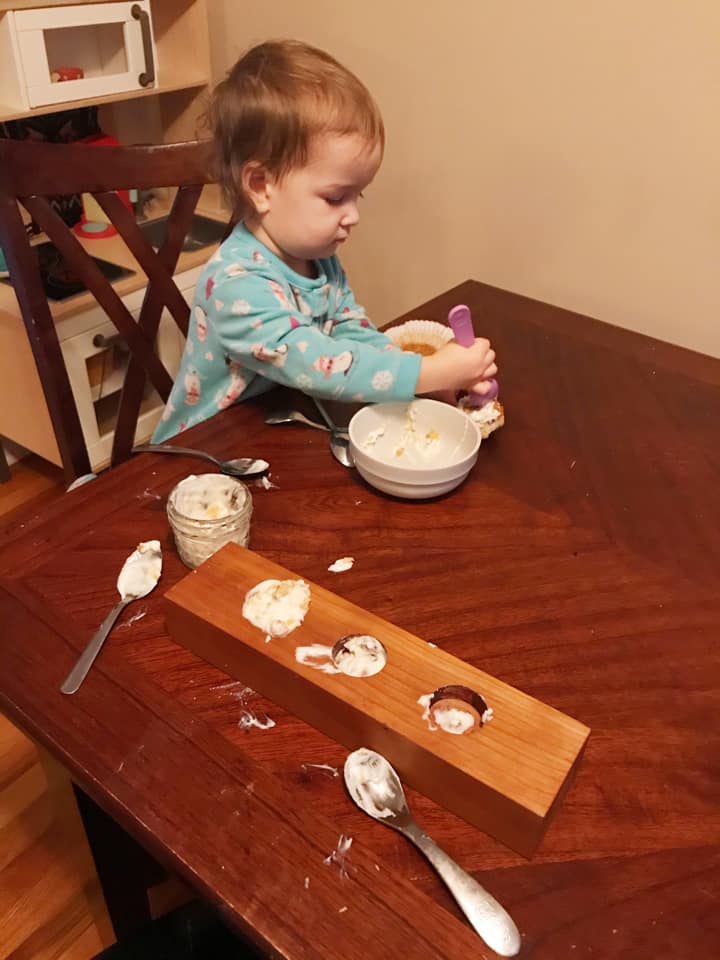 child eating and playing with yogurt