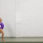 Black girl in purple unitard for gymnastics