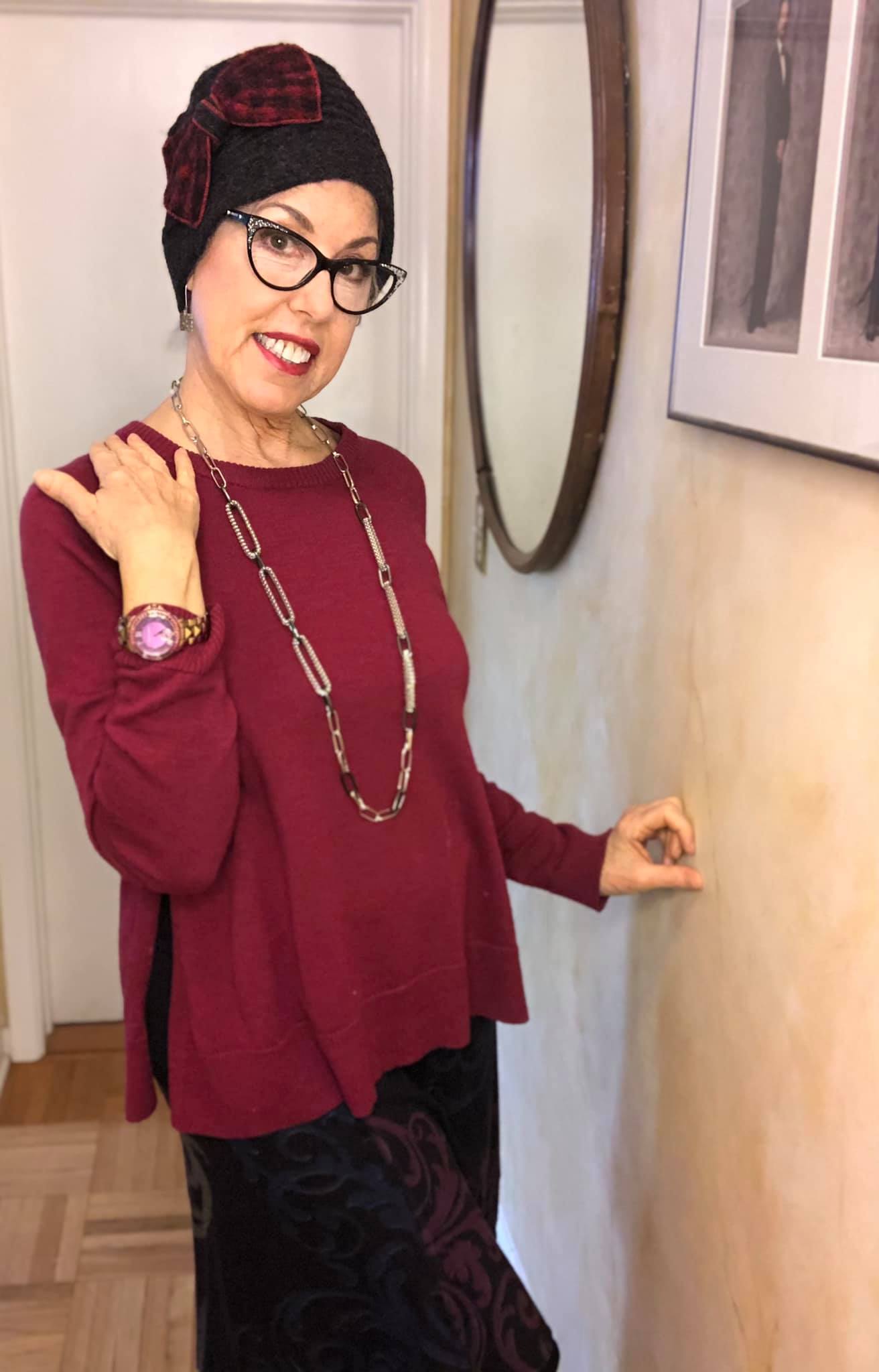 stylish woman in a hat and a maroon top