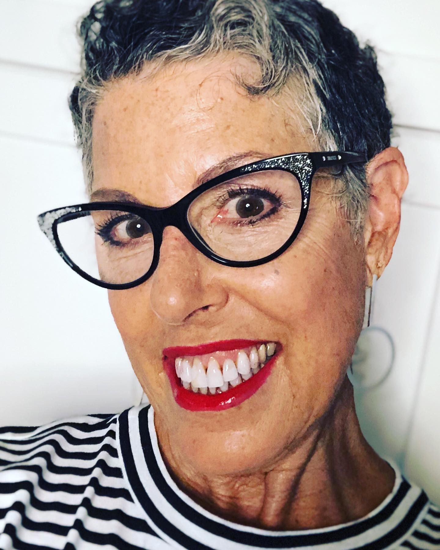 Stylish woman in cat-eye glasses and red lipstick