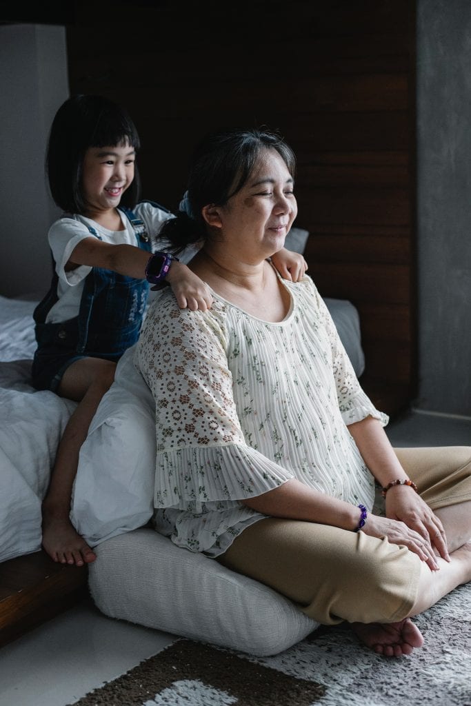 Young girl massages older woman