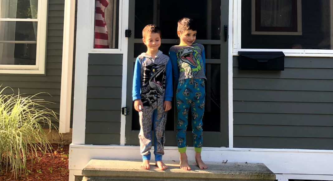 boys in pajamas posing for the first day of homeschool