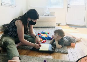 boy staring up at his Speech Language Pathologist as they work on speech exercises