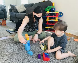 boy playing with blocks with his Speech Language Pathologist