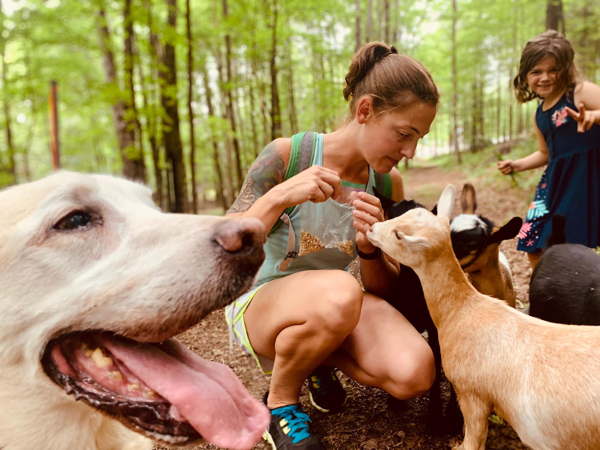 Young woman with children and goats