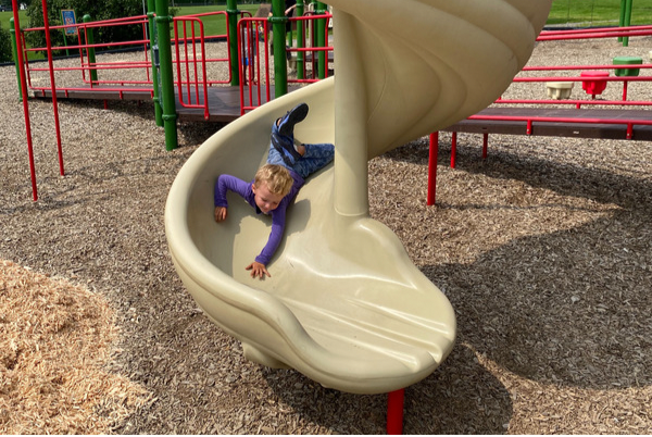 boy on playground slide