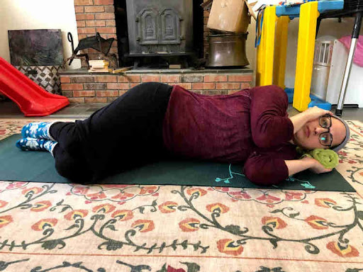 woman lying on her side with her arms bent