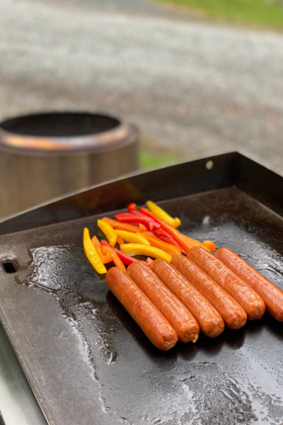 solostove and blackstone grilling hot dogs