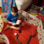 brianna boy reading in snake pen