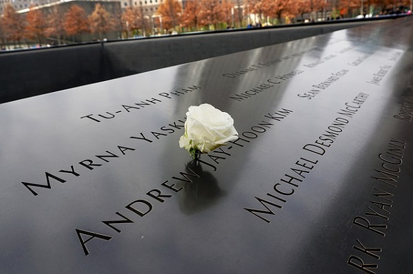 A white rose lies on a black grainte memorial commemorating people who died in the terrorist attacks of September 11.
