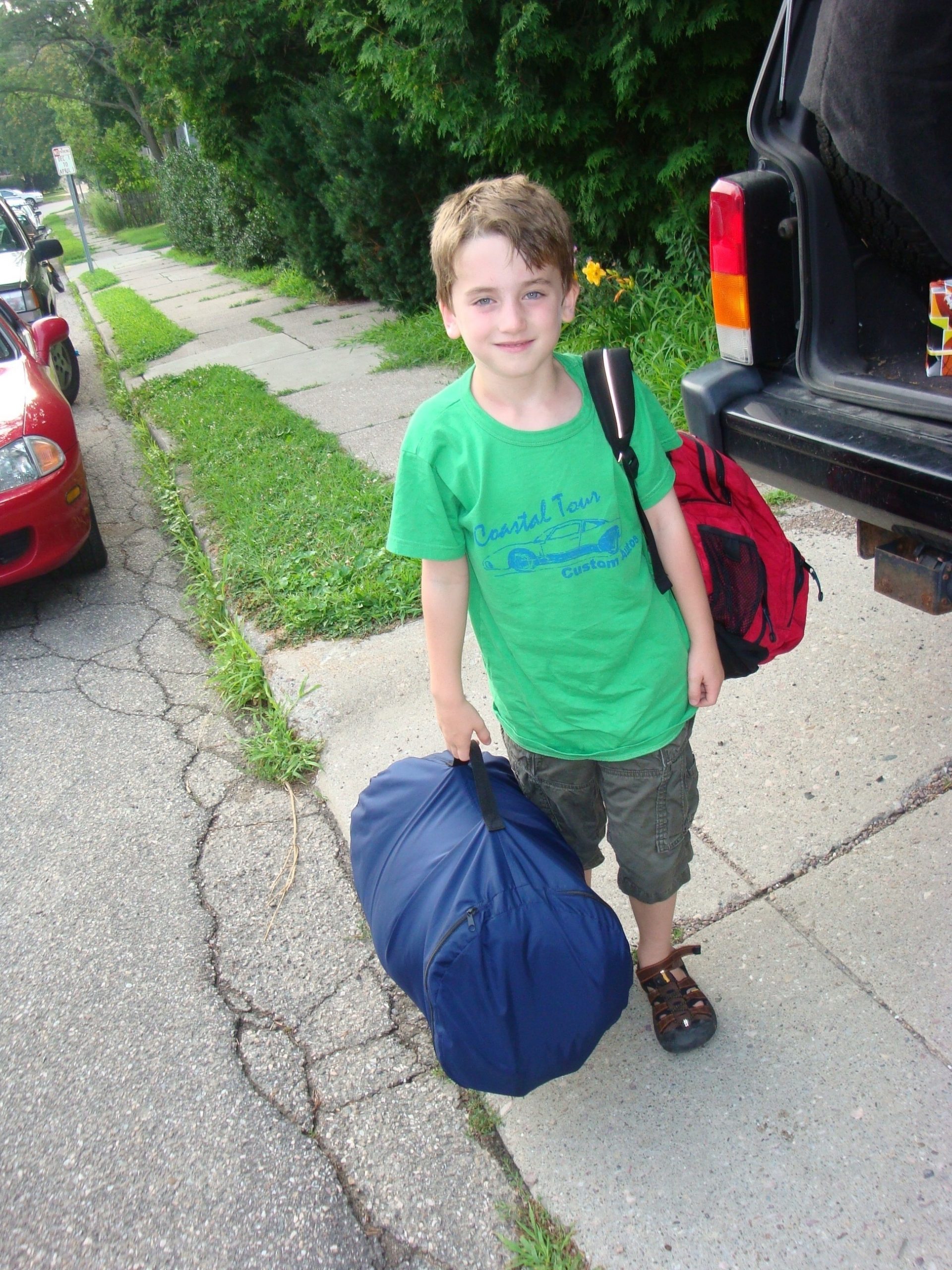 boy with backpack and sleeping bag