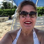 jemima on the beach with red lipstick