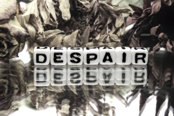 letters on dice spelling out "despair"