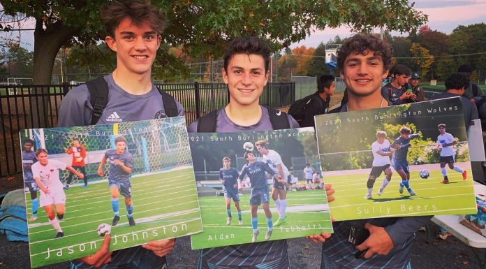 Hey There, Moms of High School Seniors Three boys stand in a line after a soccer game, sweaty and happy, holding pictures honoring them for Senior Night.