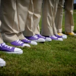 people wearing khaki pants and either purple or yellow converse sneakers