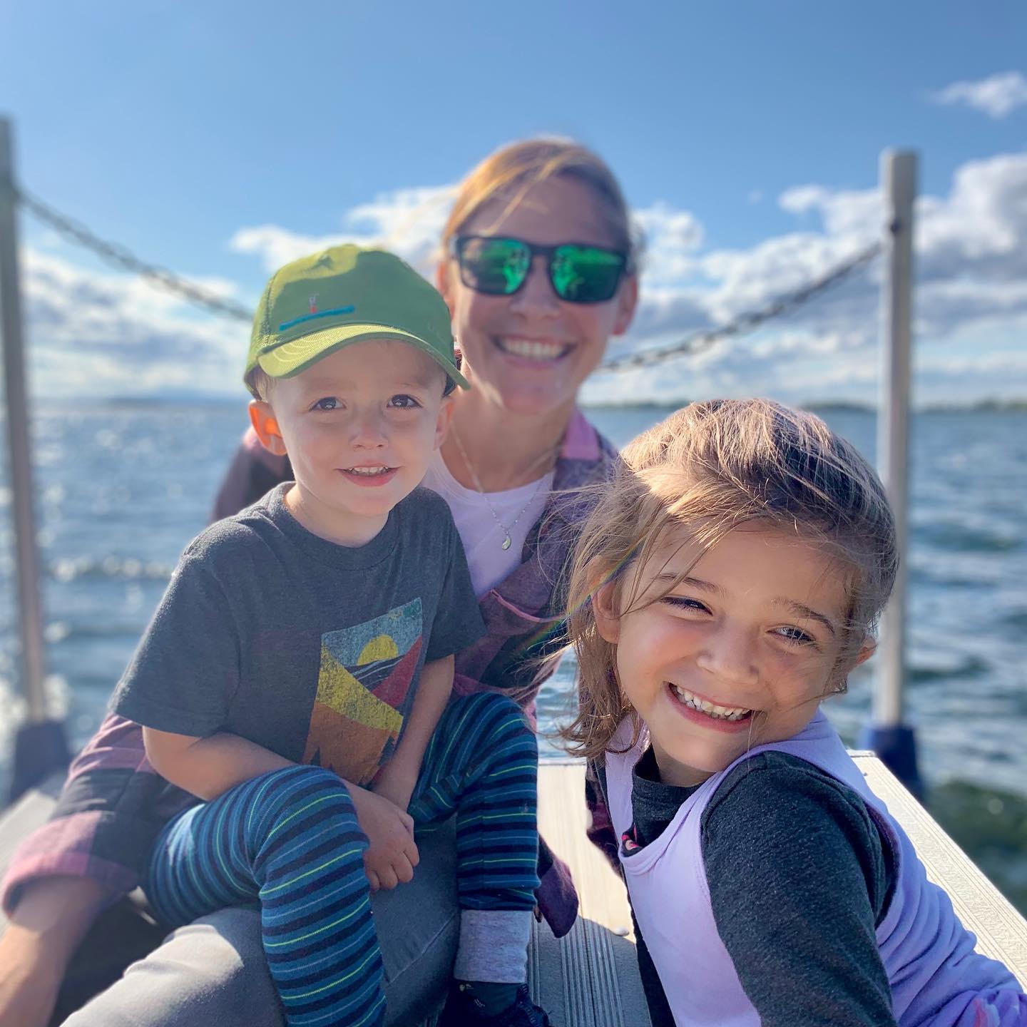 Woman with two young kids on a boat