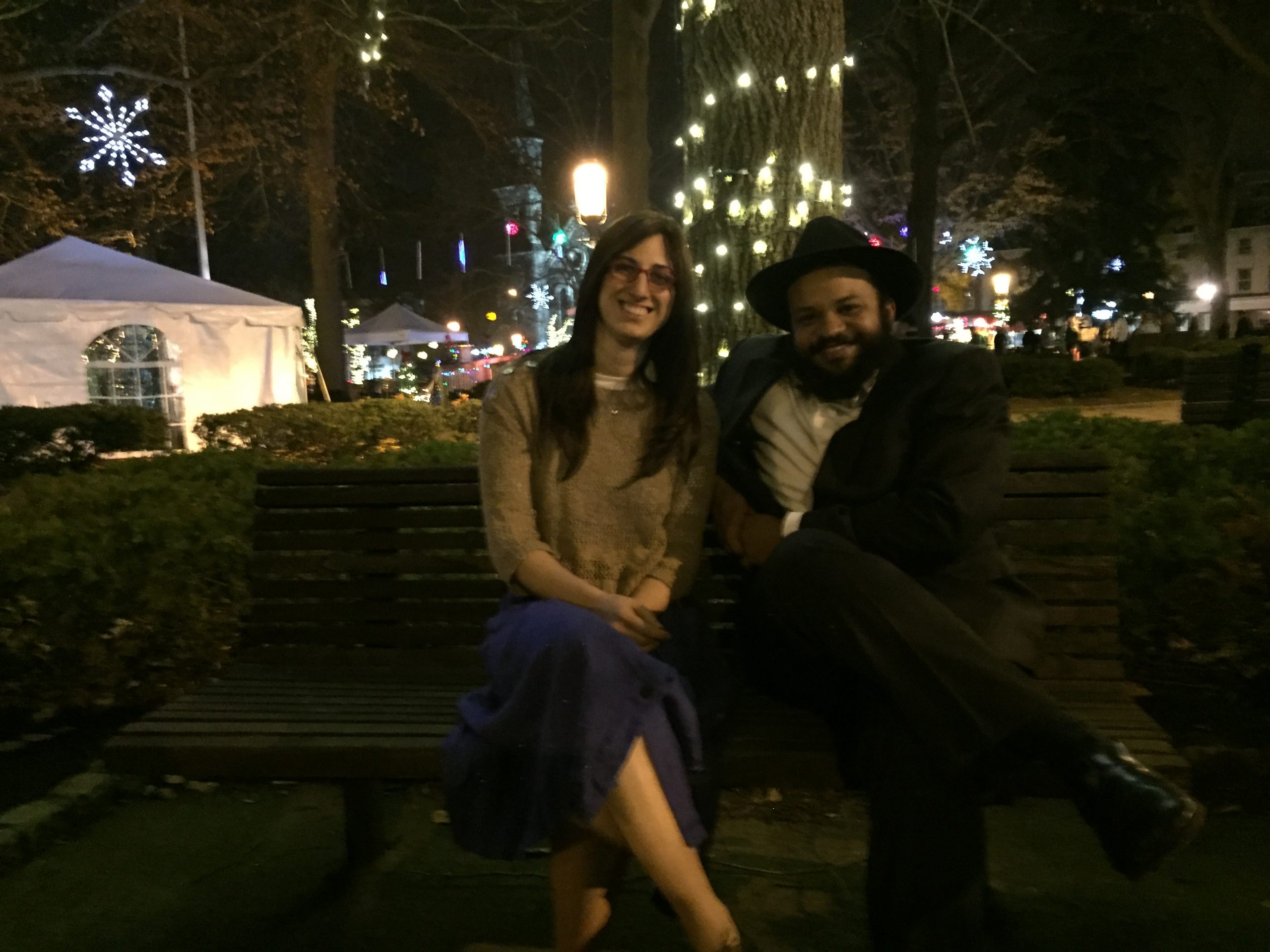 IMG_2880 Hasidic married couple on a bench in front of holiday lights