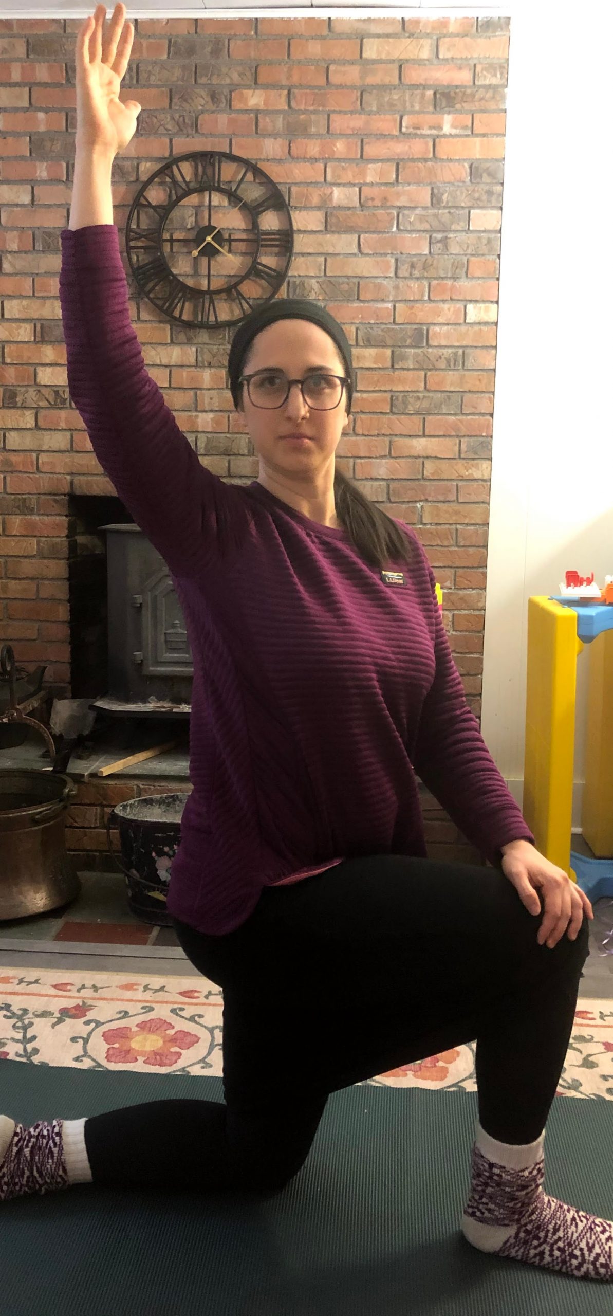 Half kneeling hip flexor stretch with a twist Woman does a half kneeling hip flexor stretch with a waist twist