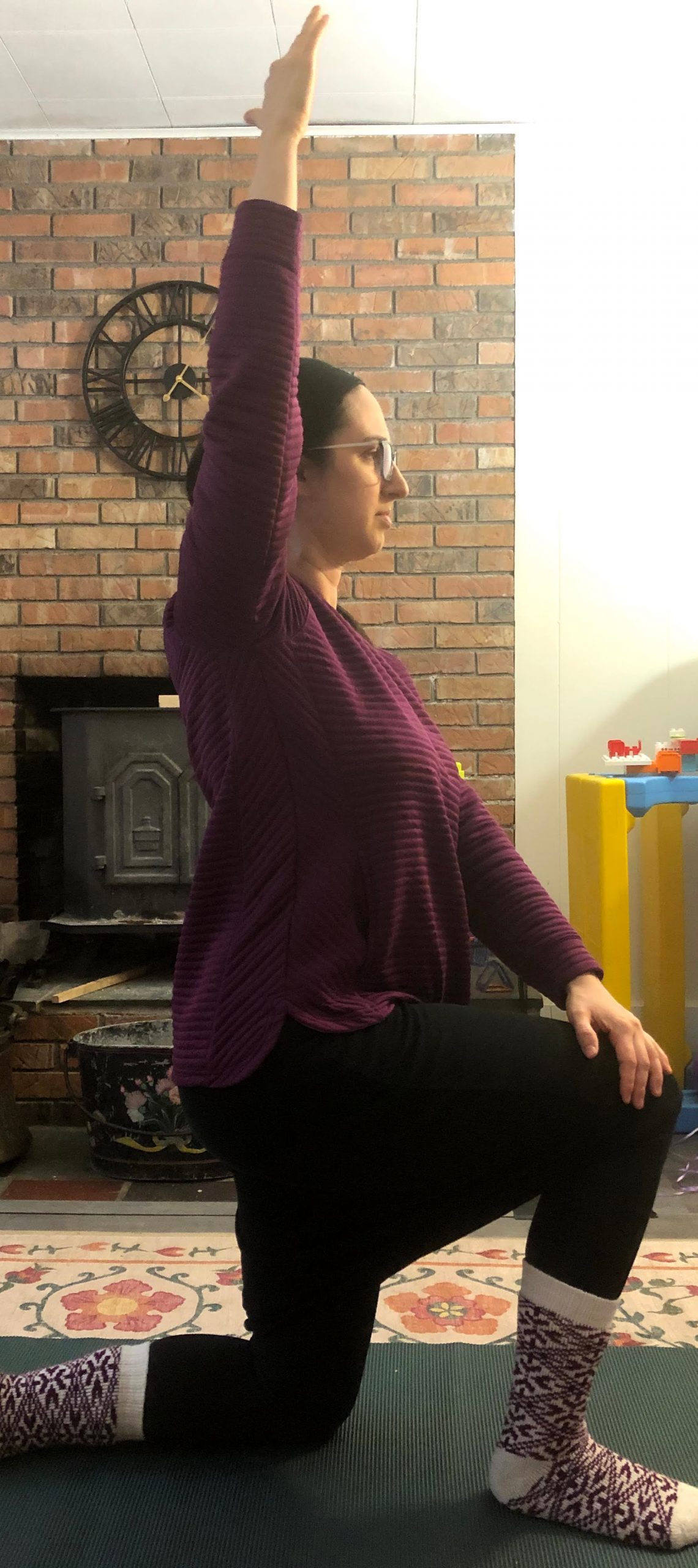 Half kneeling hip flexor stretch with a twist Woman does a half kneeling hip flexor stretch with a twist