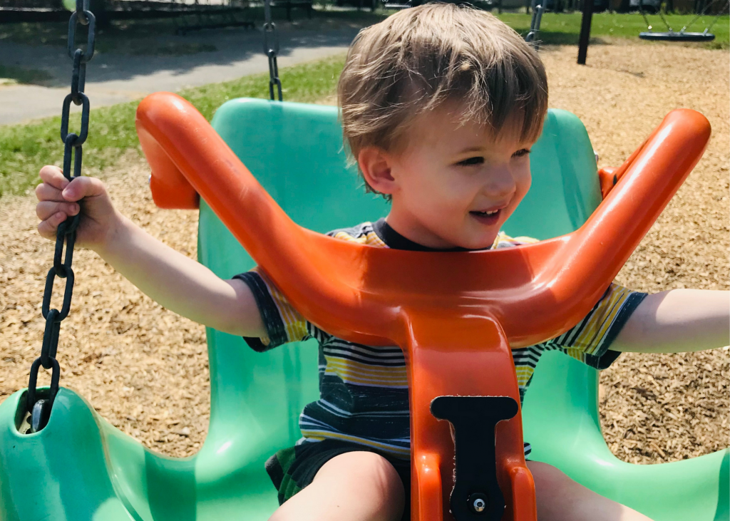 toddler swinging on inclusive ada swing seat